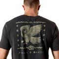 Black t-shirt with an eagle design on the back, worn by a person.
