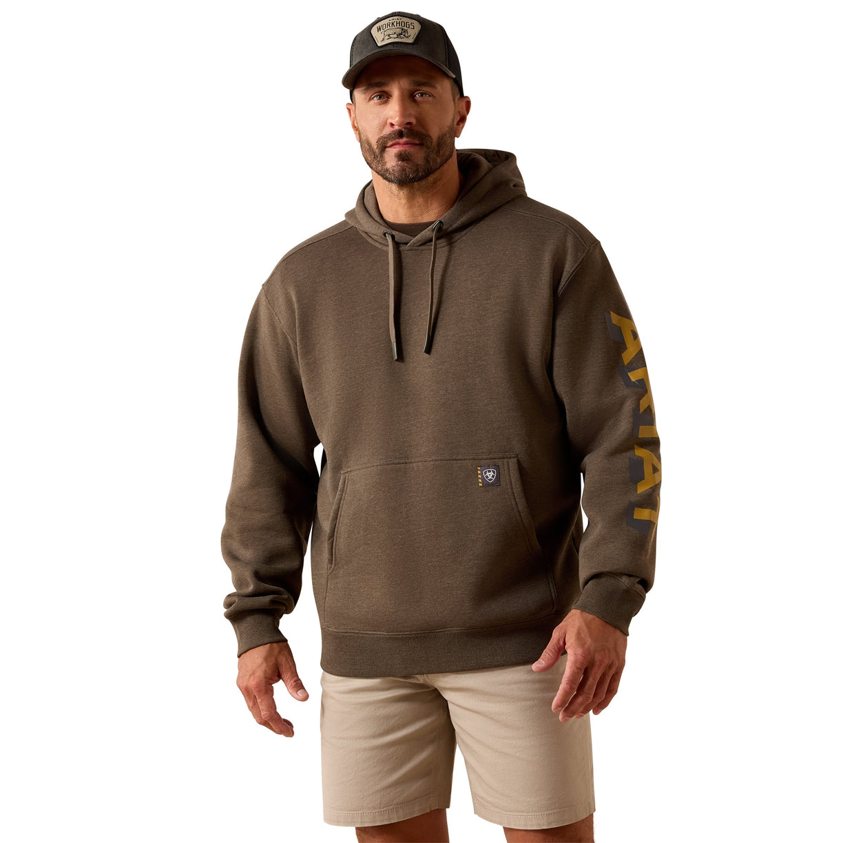 Man wearing a brown hoodie with a logo on the sleeve against a white background