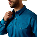 Man wearing a blue shirt with a brand logo on a white background