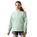 Woman wearing a light green jacket on a white background