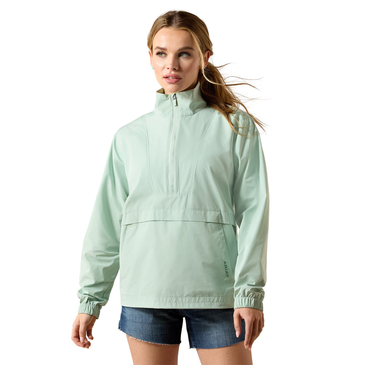 Woman wearing a light green jacket on a white background