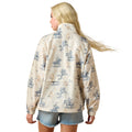 Woman wearing a patterned jacket with horse and rider design on a white background