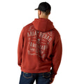 Person wearing a red hoodie with 'Ariat Rebar American Work Wear' text on the back, standing against a white background.