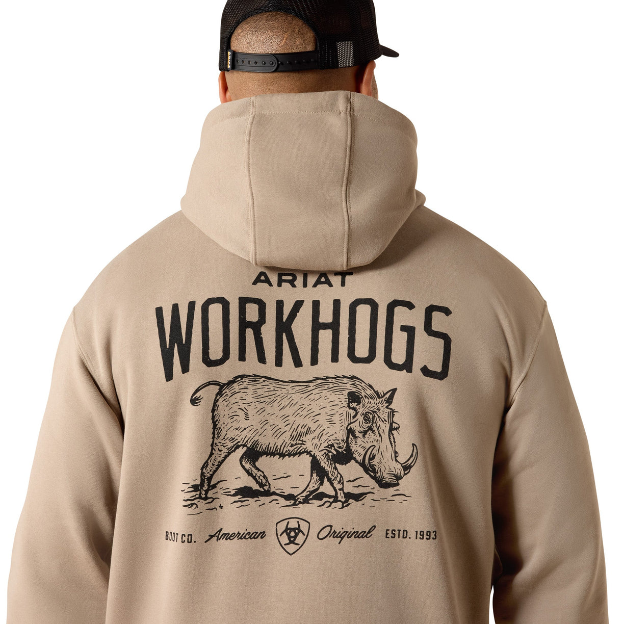 Person wearing a beige hoodie with 'Ariat Workhogs' logo on the back