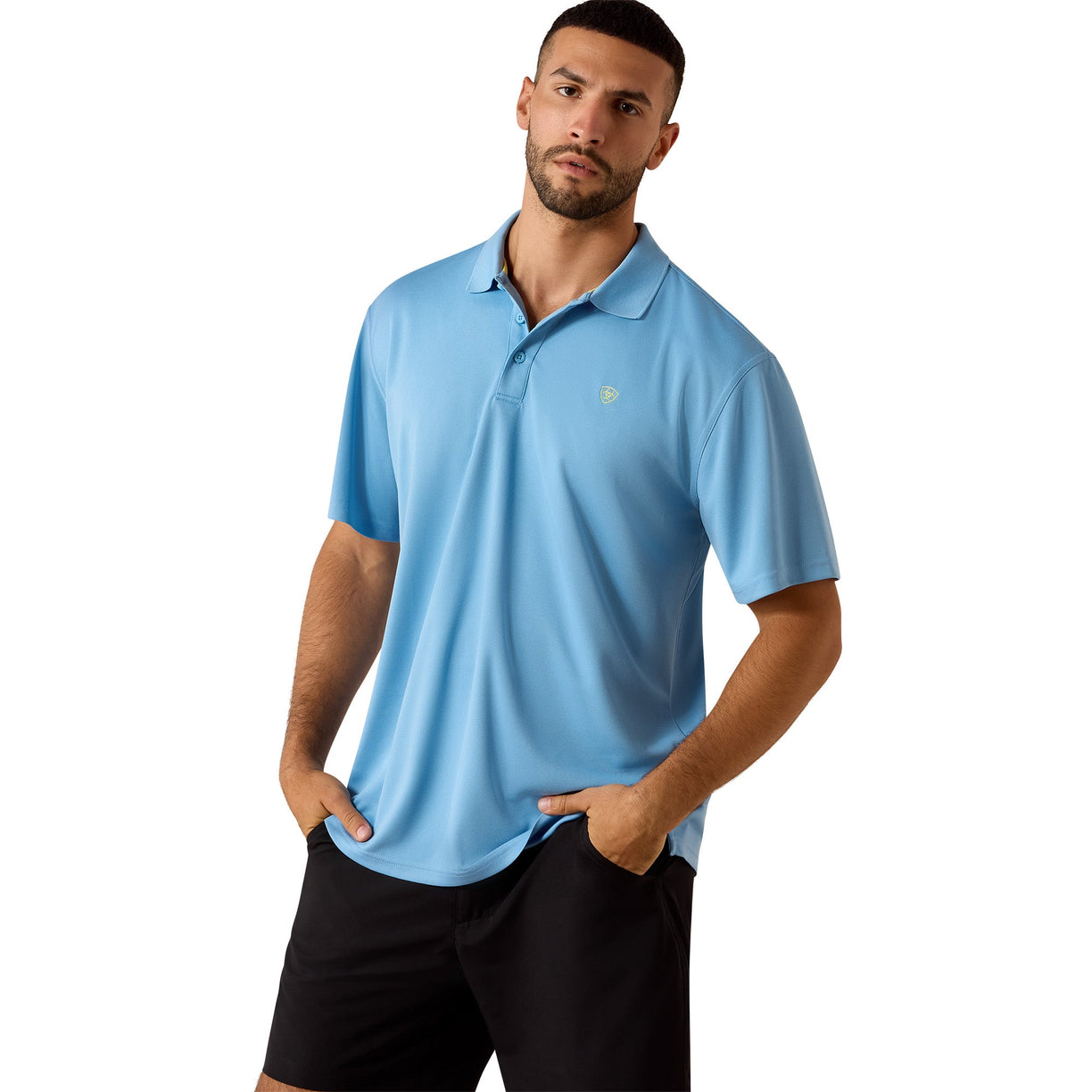 The Ariat TEK Classic Fit Polo in sky blue, on a man wearing black shorts, chest logo detail visible, front view