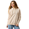Woman wearing a beige hoodie on a white background
