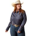 A woman modeling a dark navy long-sleeve western shirt with a white micro-dot pattern, paired with blue jeans, a brown leather belt with a large silver buckle, and a cream cowboy hat, against a solid white background.
