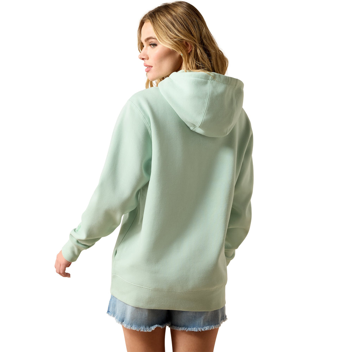 Woman wearing a light green hoodie on a white background