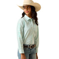 Woman wearing a light blue striped shirt, jeans, and a beige cowboy hat on a white background