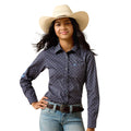 A young woman modeling a dark navy long-sleeve western shirt with a white micro-dot pattern, paired with a beige cowboy hat, blue jeans, and a brown belt against a white background.