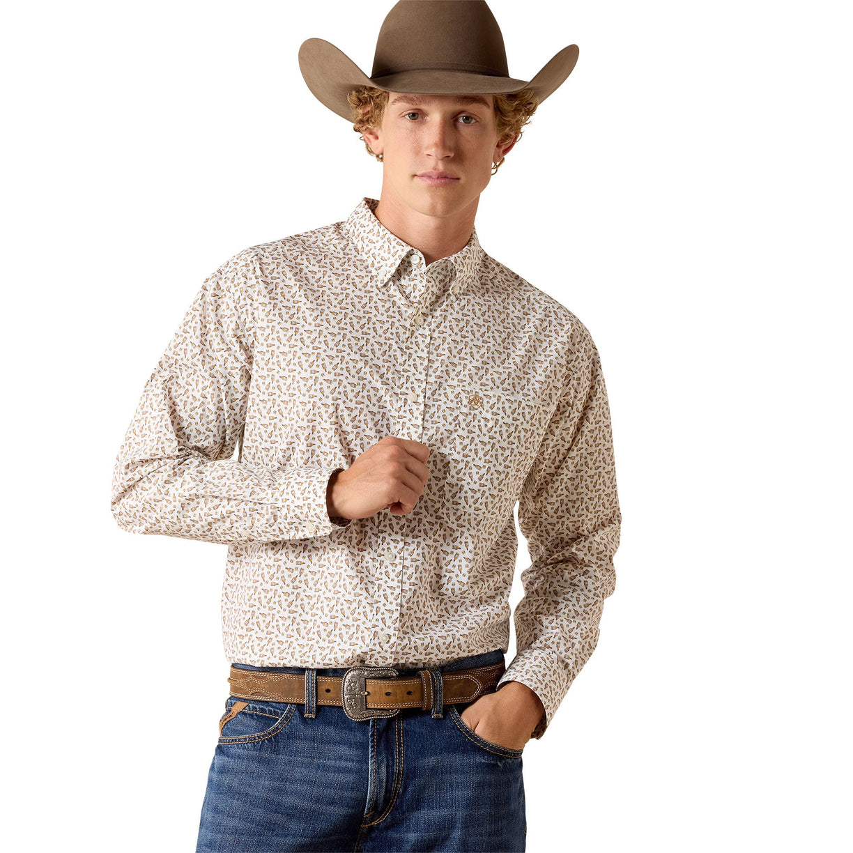 Cream button-down with a small western print, worn with a brown leather belt and denim.