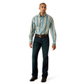 A man modeling a long-sleeve button-down shirt with vertical blue and beige geometric patterns, paired with dark blue jeans and brown shoes, on a white background.