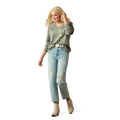 Woman wearing a green sweatshirt with text and light blue jeans on a white background