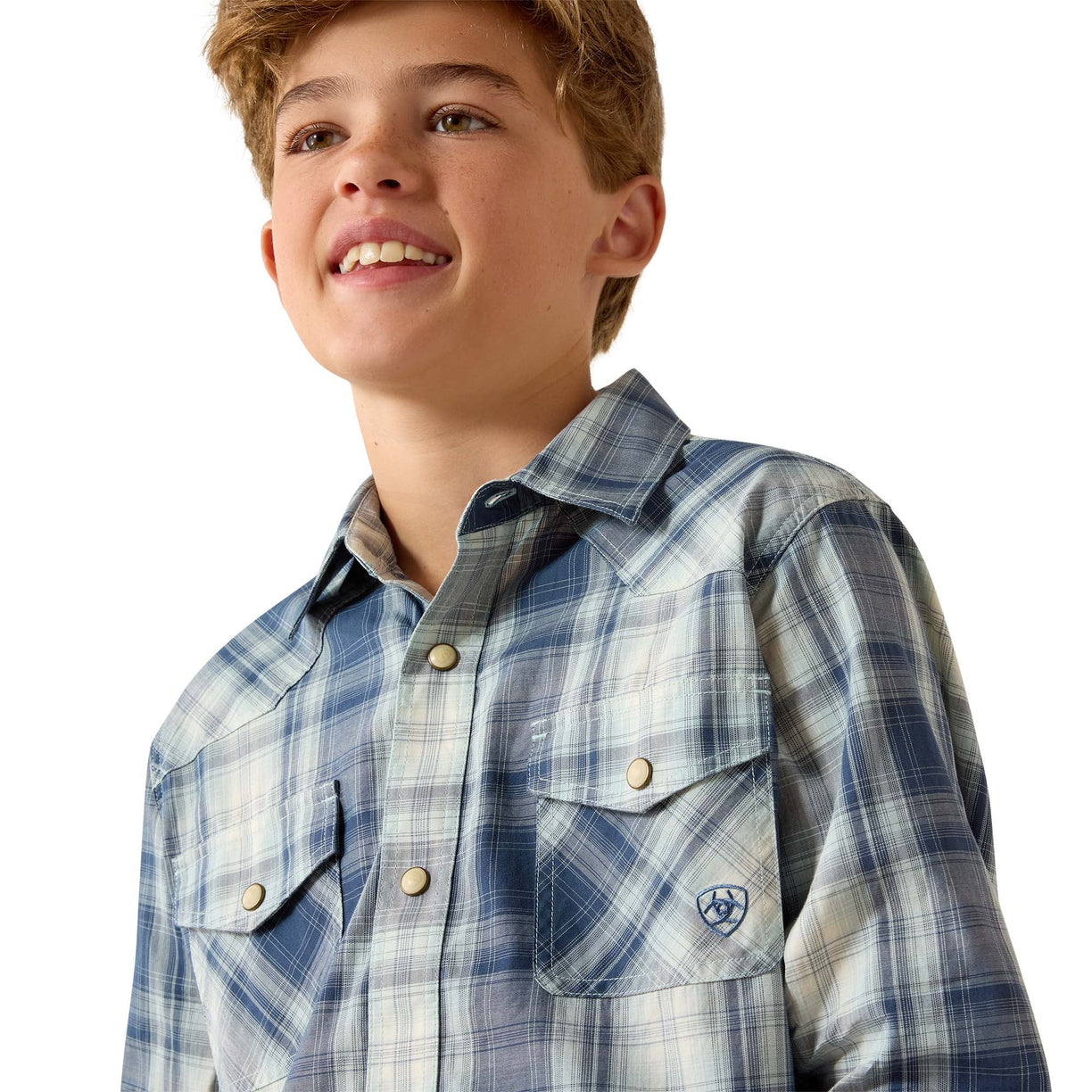 A smiling young man wearing a blue and white plaid western-style button-down shirt with two chest pockets and a small embroidered logo on the pocket, photographed against a clean white background.
