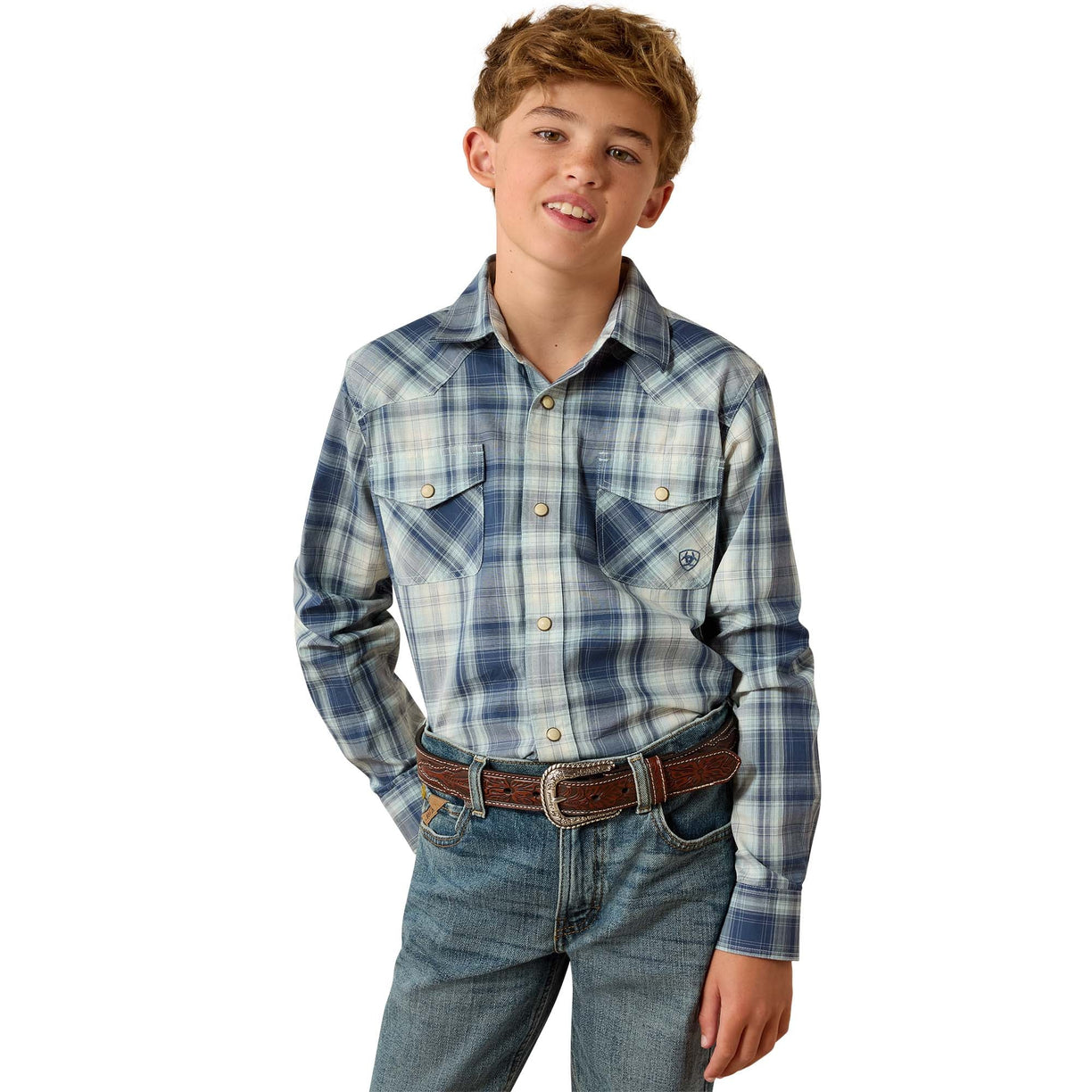 A young boy modeling a long-sleeve western plaid shirt in shades of blue, white, and gray, paired with blue jeans and a brown belt, against a solid white background.