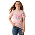 Person wearing a pink t-shirt with text and graphics on a white background