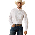 White shirt with a small foulard print, tucked into dark denim with a brown belt.