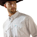 Man wearing a patterned shirt and cowboy hat on a white background
