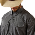 Man wearing a black and white checkered shirt with a beige cowboy hat on a white background