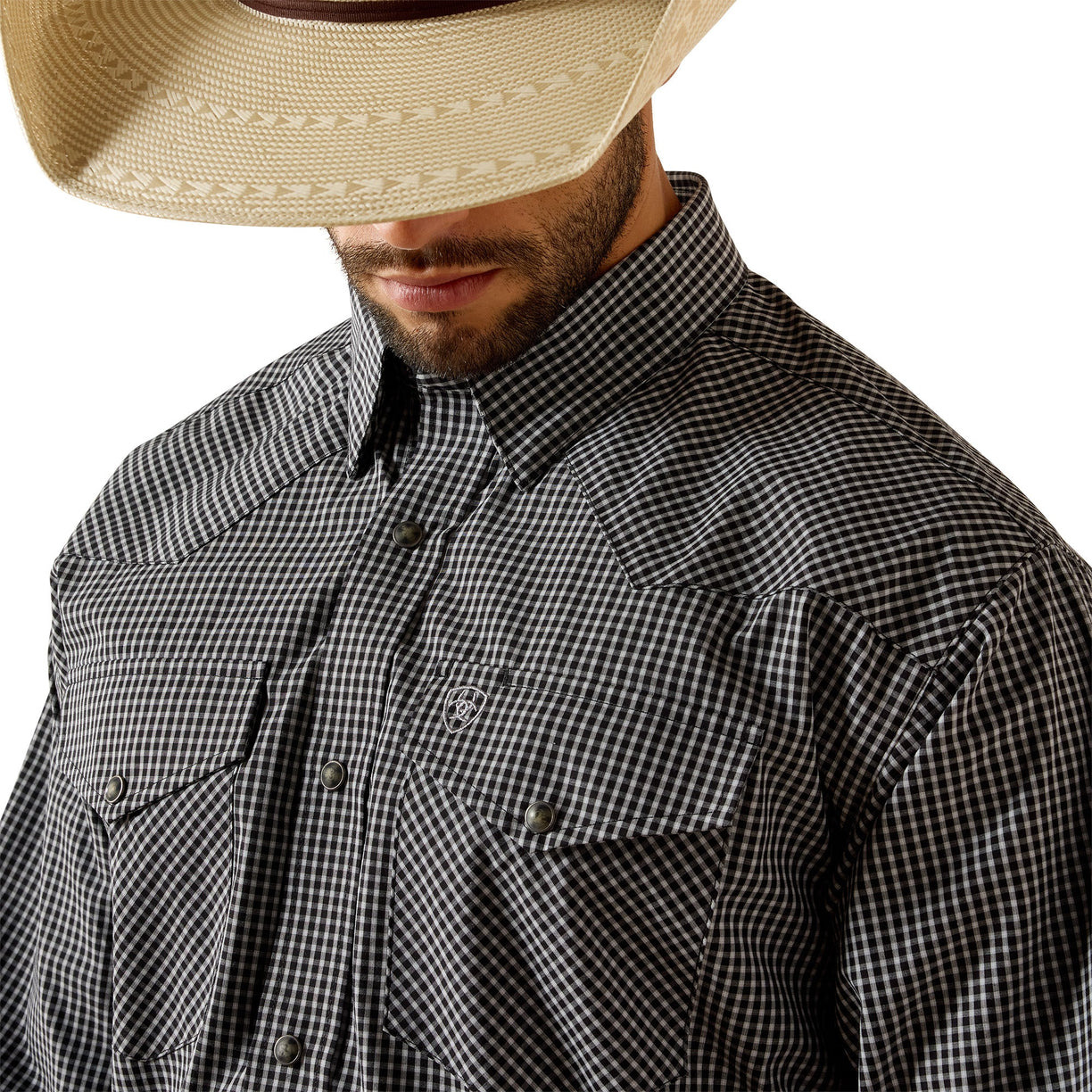 Man wearing a black and white checkered shirt with a beige cowboy hat on a white background