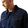 Man wearing a blue denim jacket with a brown collar on a white background