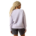 Person wearing a light gray sweatshirt and dark gray shorts on a white background