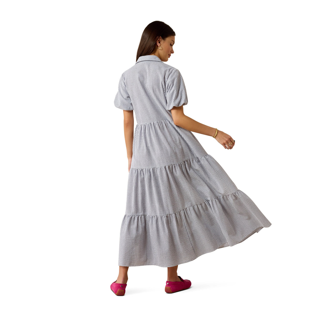 Woman wearing a gray stripe dress on a white background