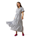 Woman wearing a blue and white striped dress on a white background
