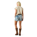 Woman wearing denim shorts and brown cowboy boots on a white background
