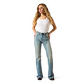 Woman wearing light blue jeans and a white top on a white background