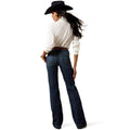 Person wearing a white shirt, dark blue jeans, and a black cowboy hat on a white background