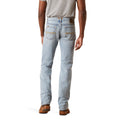 Light blue jeans worn by a person on a white background