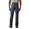 Person wearing blue jeans on a white background