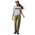 Woman wearing an Ariat sweatshirt and pants on a white background