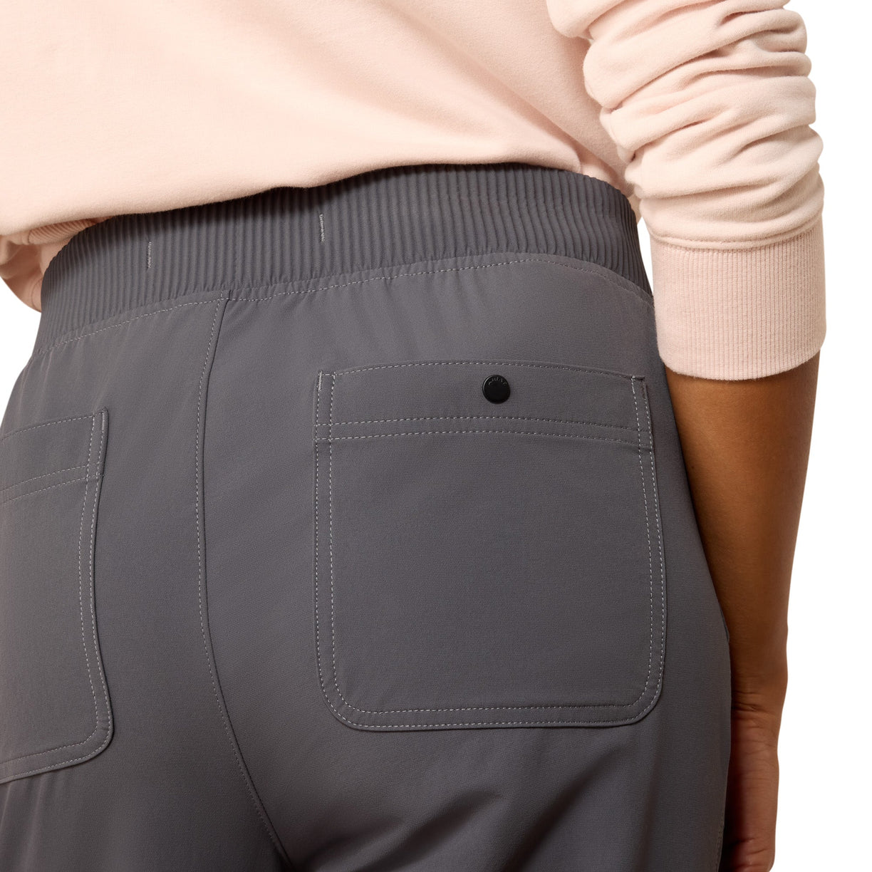 Gray pants with a pocket detail worn by a person, on a white background