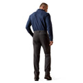 Man wearing a blue shirt and black pants on a white background
