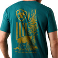 Teal t-shirt with yellow graphic design on the back, featuring a bear and trees.