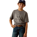 Child wearing a grey t-shirt with a logo and blue jeans