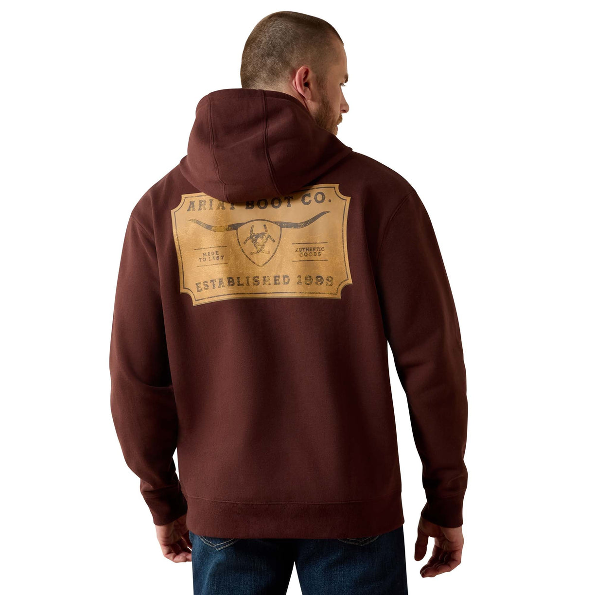 Man wearing a brown hoodie with a brand logo on the back against a white background