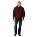 Man wearing a brown hoodie and blue jeans on a white background