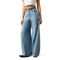 Person wearing light blue jeans on a white background