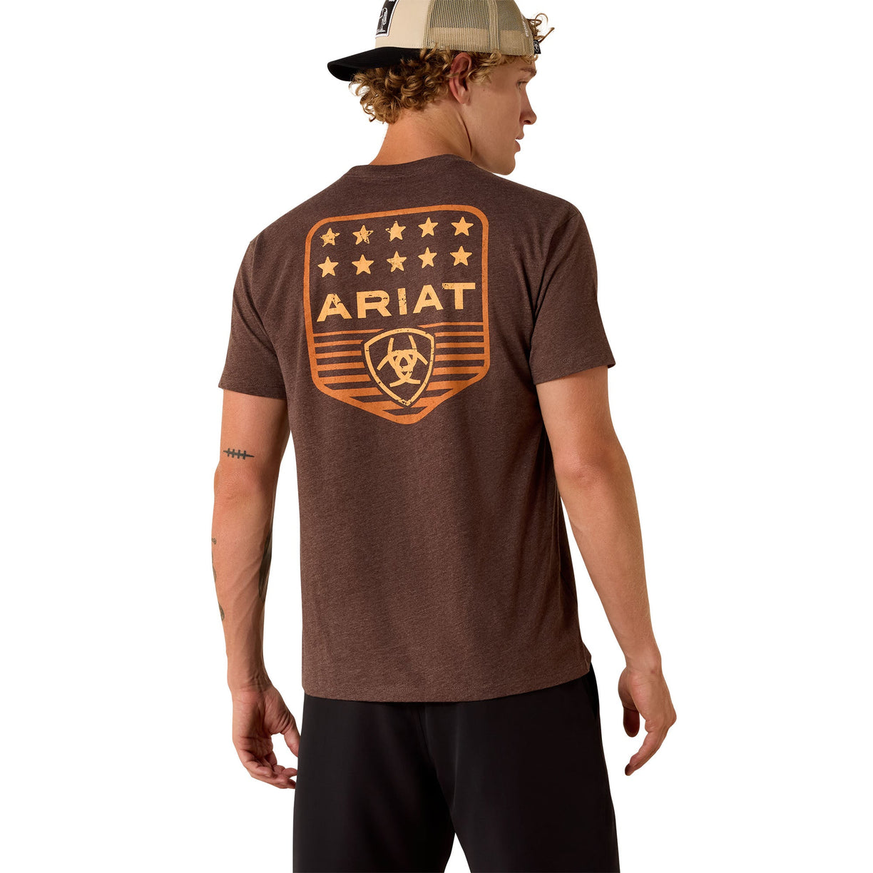 Man wearing a brown Ariat t-shirt with a logo on the back against a white background