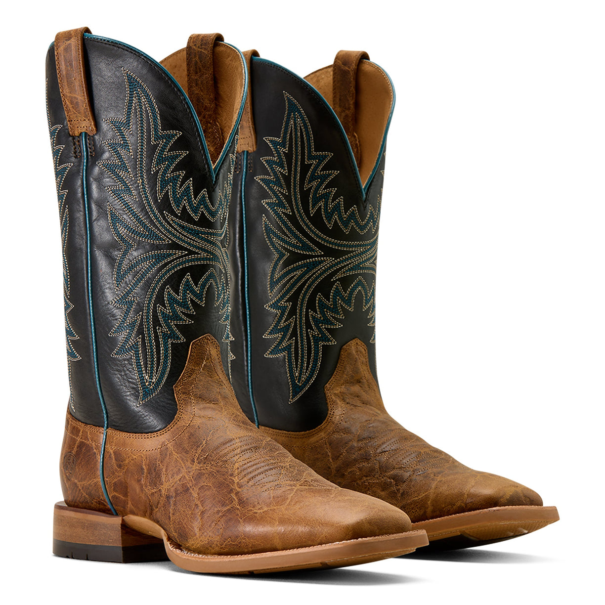 Pair of brown and black cowboy boots with intricate designs on a white background