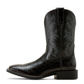 Black cowboy boot with embossed design on a white background
