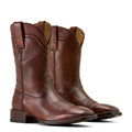Pair of brown leather boots on a beige background