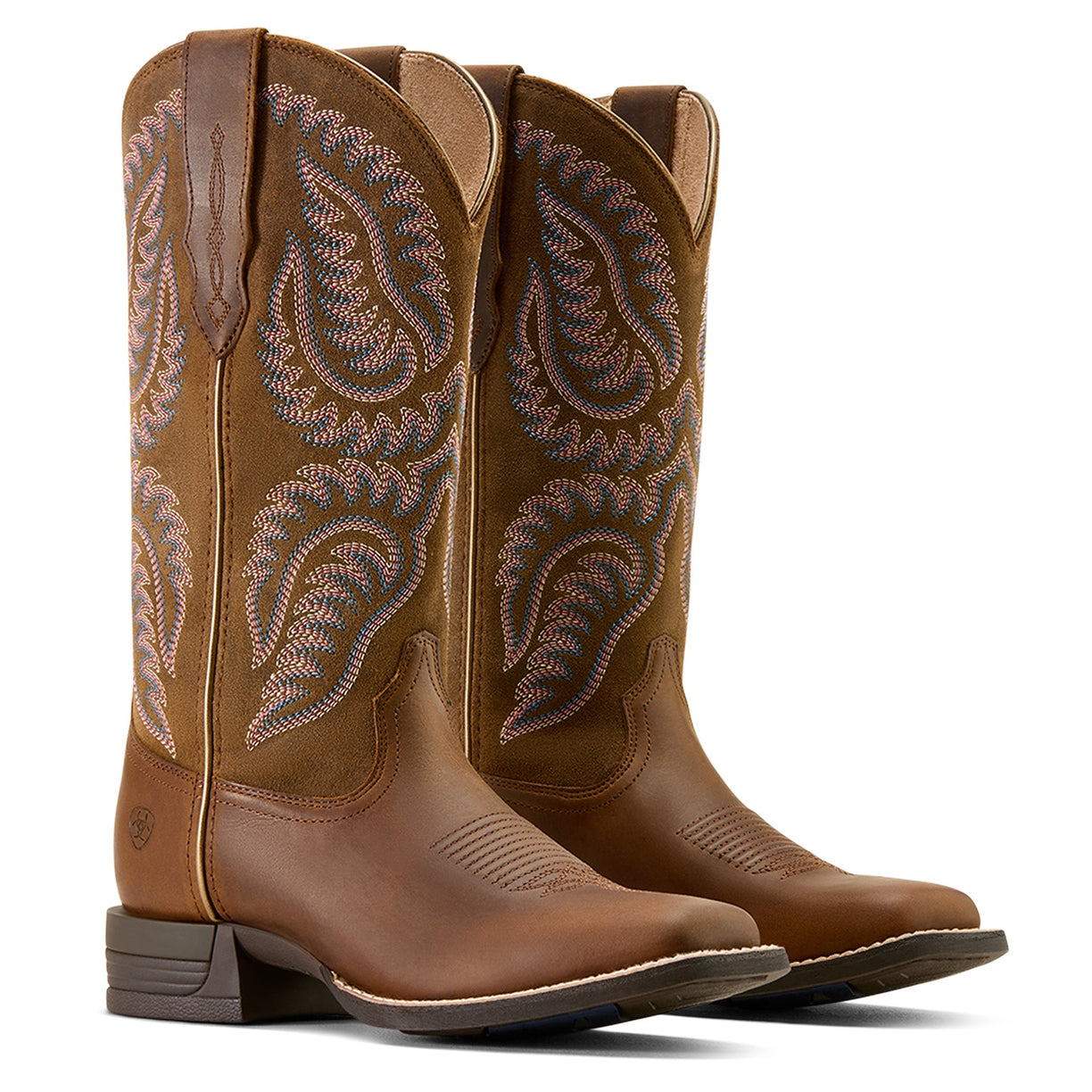 Pair of brown cowboy boots with intricate stitching on a white background
