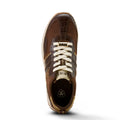 Brown sneaker with white laces on a white background