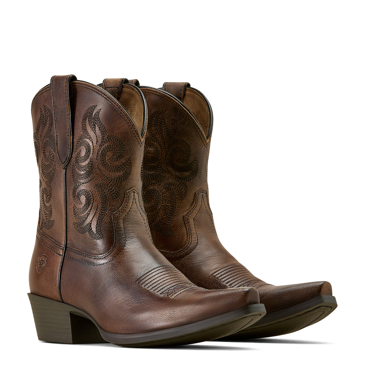 Pair of brown cowboy boots with intricate designs on a white background
