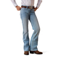 Person wearing light blue Ariat denim jeans and brown boots 