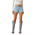 Woman wearing light blue mid length Ariat denim shorts and grey knee-high boots 